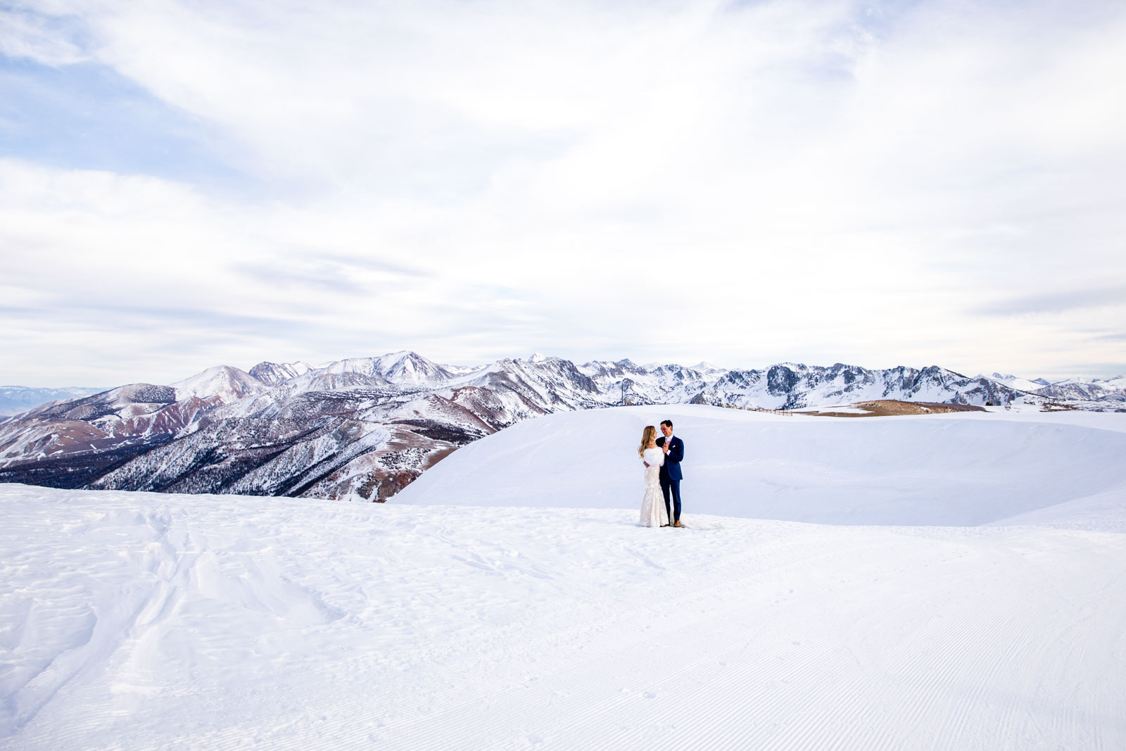 Bride and groom gaze on Mammoth Mountain with the Eastern Sierra mountains