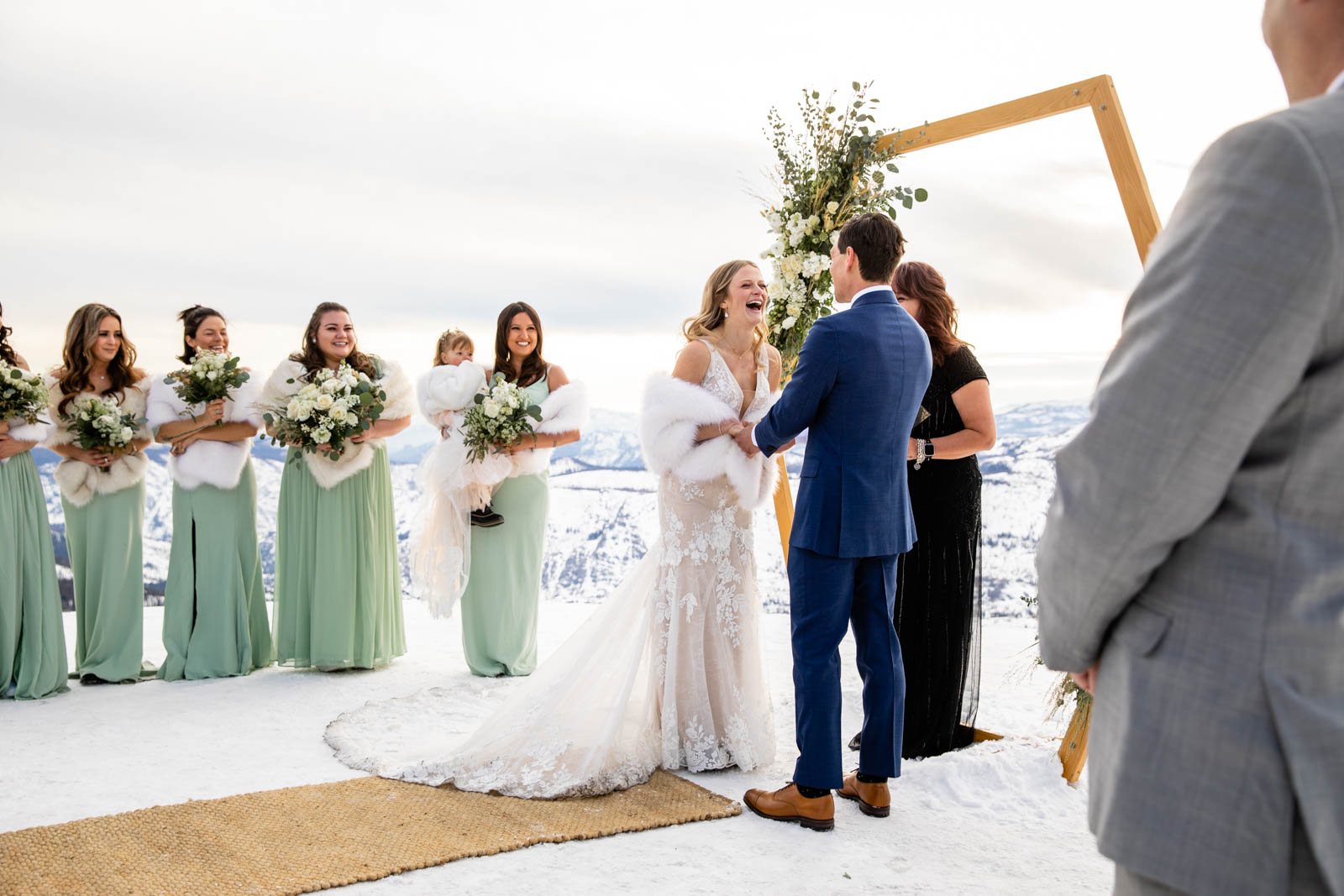 Bride laughs during ceremony on Mammoth Mountain